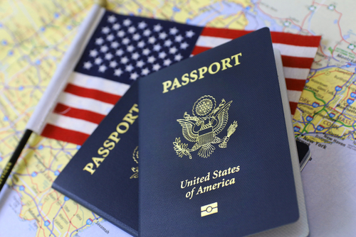 Two US passport and a flag.