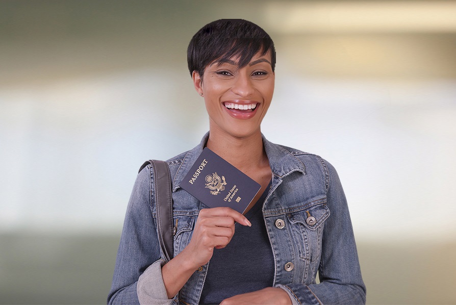 A woman smiling and holding her passport